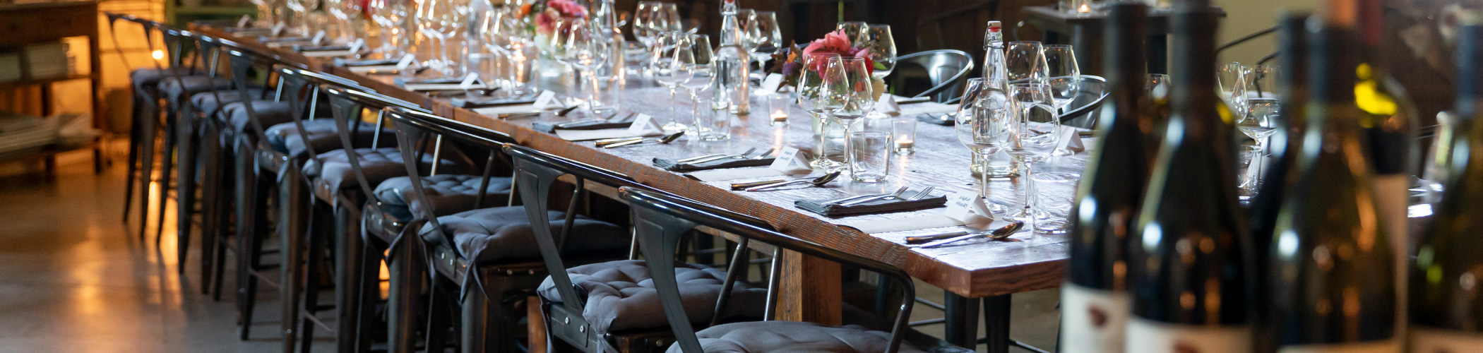 A barnwood table at The Kitchen at Middlground Farms set for a private event.